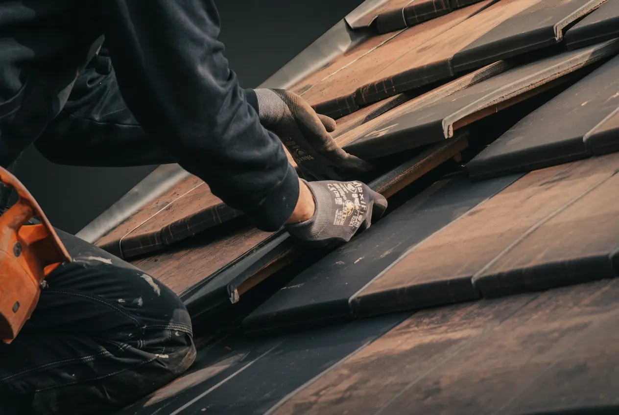 Craftsmanship detail, hands laying roof tiles